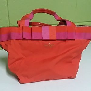 Kate Spade purse with bow ribbon and zipper.